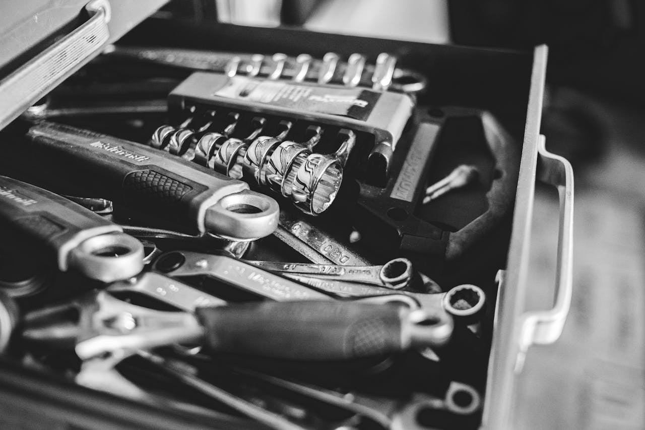 From above black and white cabinet drawer with assorted repair tools in craftsmanship